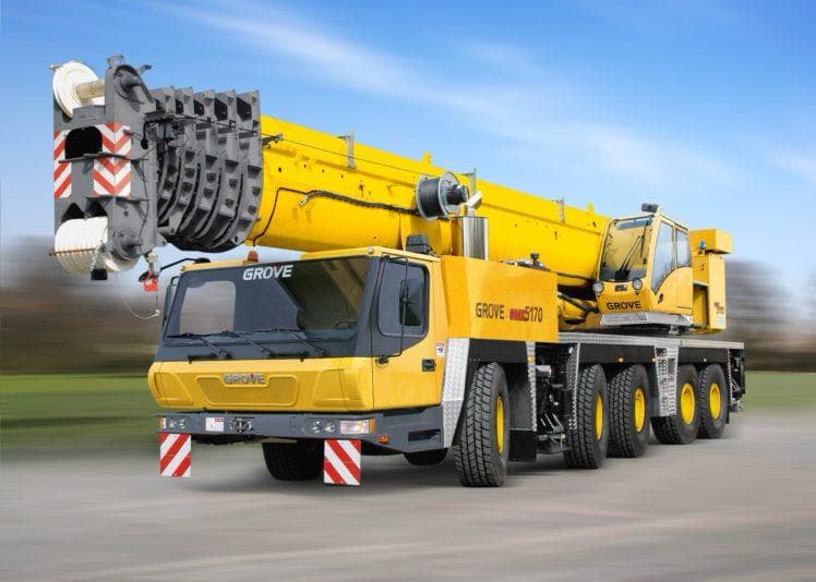 Yellow all-terrain mobile crane with its boom retracted